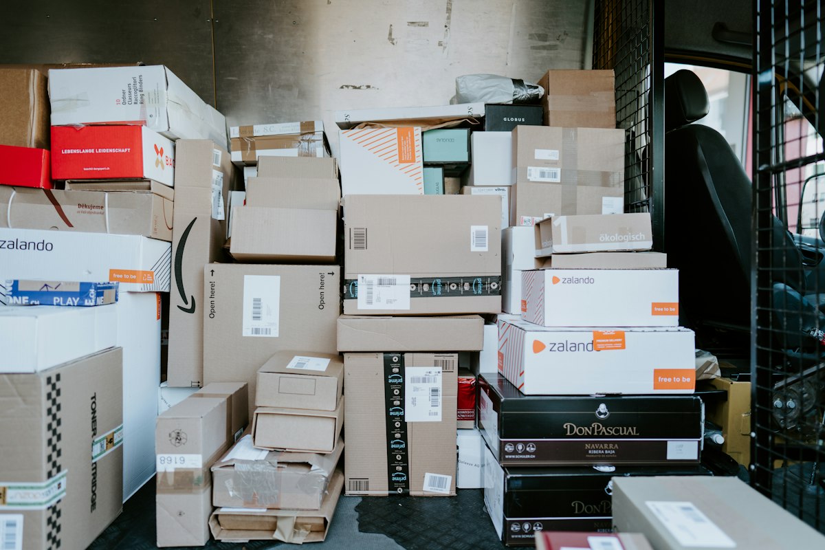 Stack of cardboard boxes loaded in the back of a delivery van